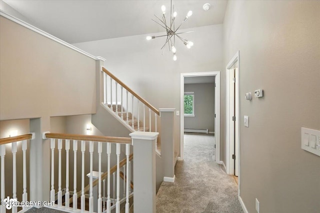 5612 E Beaver Ave, Wasilla, AK 99654 - hallway with carpet floors, baseboard heating, a chandelier, and an upstairs landing