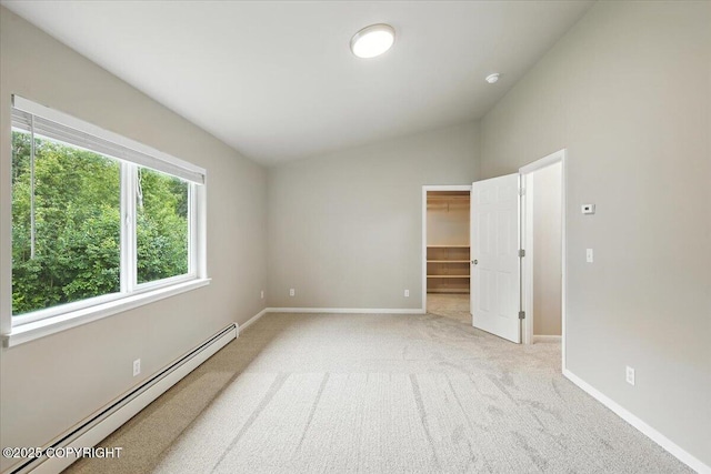 5612 E Beaver Ave, Wasilla, AK 99654 - unfurnished bedroom with a baseboard heating unit, lofted ceiling, light carpet, and a spacious closet