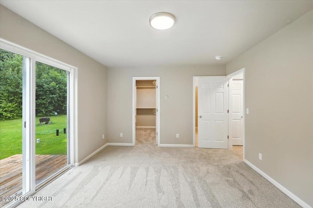 5612 E Beaver Ave, Wasilla, AK 99654 - unfurnished bedroom with access to exterior, light colored carpet, a walk in closet, and a closet