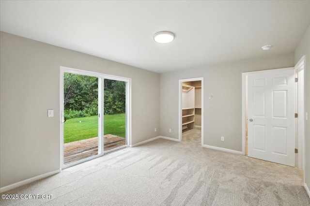 5612 E Beaver Ave, Wasilla, AK 99654 - unfurnished bedroom featuring access to outside, carpet floors, a walk in closet, and a closet