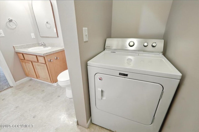 5612 E Beaver Ave, Wasilla, AK 99654 - washroom with washer / clothes dryer and baseboards