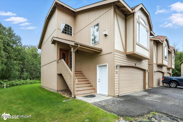 5612 E Beaver Ave, Wasilla, AK 99654 - multi unit property featuring a front yard, stairway, a garage, and driveway