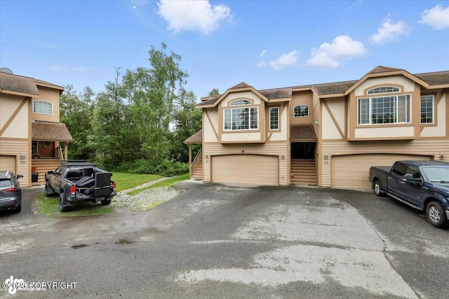 5612 E Beaver Ave, Wasilla, AK 99654 - view of front facade with an attached garage, driveway, and stucco siding