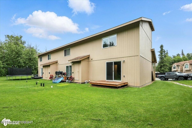 5612 E Beaver Ave, Wasilla, AK 99654 - rear view of property featuring a trampoline, a wooden deck, and a yard
