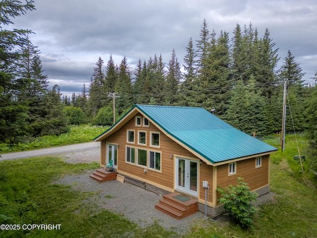 40996 Woodman Ln, Homer, AK 99603 - view of front of property with a metal roof, a view of trees, and french doors