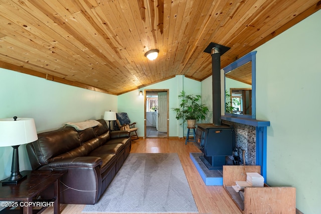 40996 Woodman Ln, Homer, AK 99603 - living room with a wood stove, lofted ceiling, healthy amount of natural light, wood finished floors, and wood ceiling