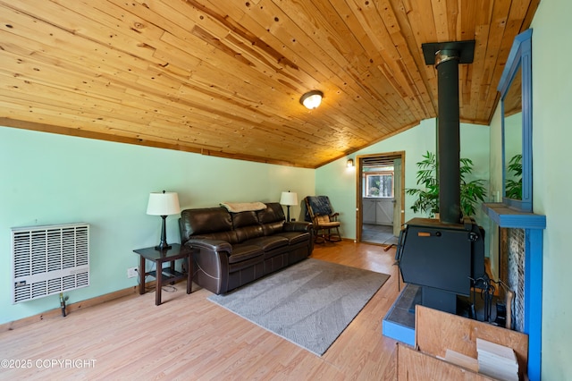 40996 Woodman Ln, Homer, AK 99603 - living area with lofted ceiling, a wood stove, wood ceiling, wood finished floors, and heating unit