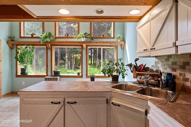 40996 Woodman Ln, Homer, AK 99603 - kitchen with white cabinetry, backsplash, and light tile patterned floors