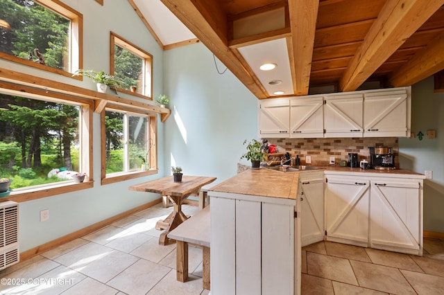 40996 Woodman Ln, Homer, AK 99603 - kitchen with light tile patterned floors, decorative backsplash, white cabinetry, light countertops, and recessed lighting