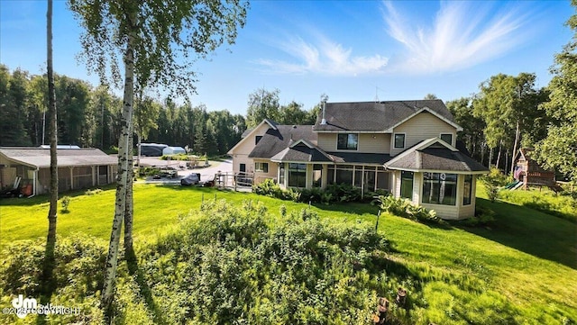 9803 W King Arthur Dr, Wasilla, AK 99623 - view of front of home featuring a front lawn and a sunroom