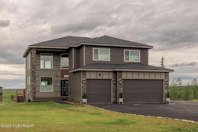 5062 E Calf Cir, Wasilla, AK 99654 - view of front facade featuring asphalt driveway, a garage, a front lawn, roof with shingles, and board and batten siding