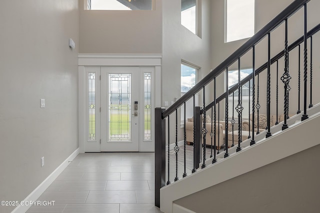 5062 E Calf Cir, Wasilla, AK 99654 - foyer entrance with a high ceiling, stairway, and tile patterned flooring