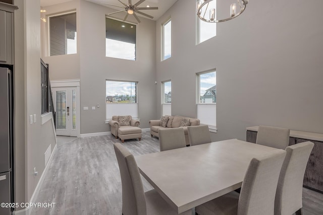5062 E Calf Cir, Wasilla, AK 99654 - dining room with a chandelier, light wood-style floors, plenty of natural light, and a towering ceiling