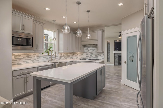 5062 E Calf Cir, Wasilla, AK 99654 - kitchen with appliances with stainless steel finishes, gray cabinets, decorative backsplash, light countertops, and recessed lighting