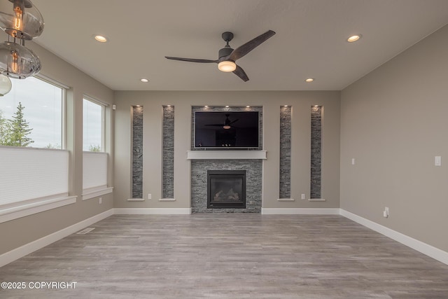 5062 E Calf Cir, Wasilla, AK 99654 - unfurnished living room with a ceiling fan, wood finished floors, recessed lighting, and a glass covered fireplace