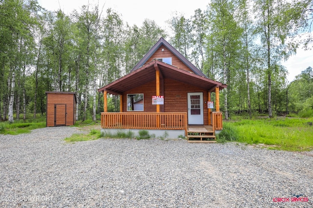 20057 E Caswell Lakes Rd, Willow, AK 99688 - view of front of property with a storage unit, a porch, and driveway