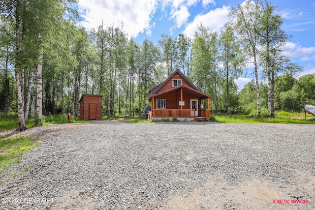 20057 E Caswell Lakes Rd, Willow, AK 99688 - rustic home with covered porch, a storage shed, and driveway