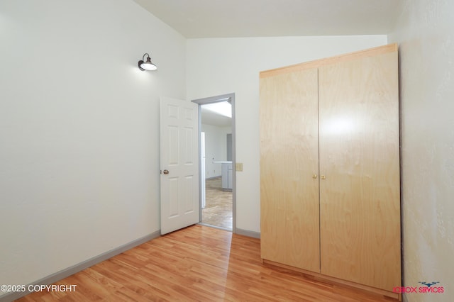 20057 E Caswell Lakes Rd, Willow, AK 99688 - unfurnished bedroom featuring light wood-style floors, a closet, and lofted ceiling