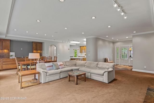 1103 Inlet Woods Dr, Kenai, AK 99611 - living room featuring light colored carpet, track lighting, ornamental molding, arched walkways, and recessed lighting