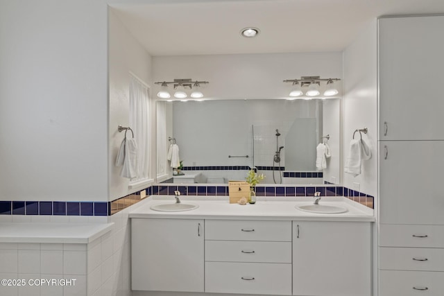 1103 Inlet Woods Dr, Kenai, AK 99611 - bathroom featuring double vanity, tiled shower, and tile walls