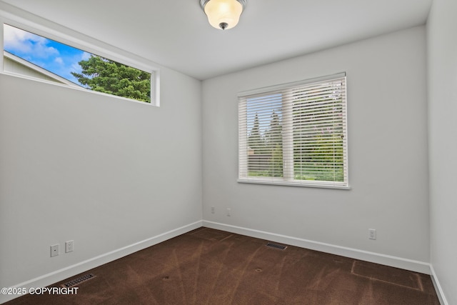1103 Inlet Woods Dr, Kenai, AK 99611 - spare room featuring baseboards and dark carpet