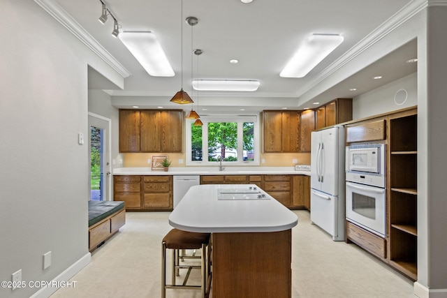 1103 Inlet Woods Dr, Kenai, AK 99611 - kitchen featuring white appliances, brown cabinetry, light countertops, crown molding, and a center island
