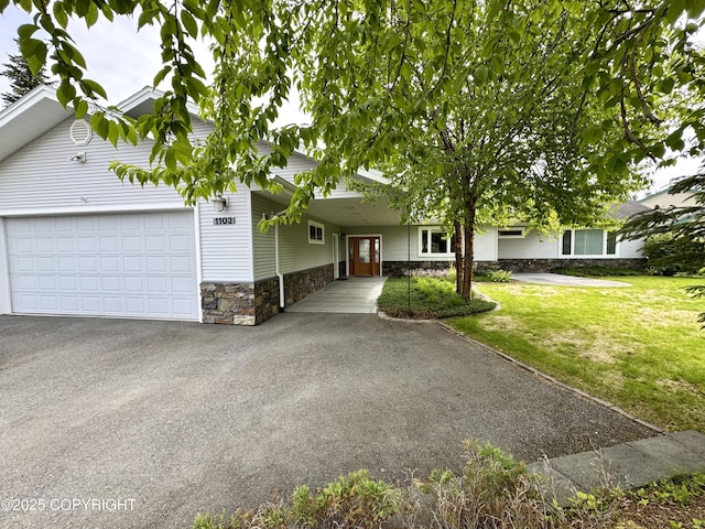 1103 Inlet Woods Dr, Kenai, AK 99611 - view of front of house featuring stone siding, driveway, an attached garage, and a front yard