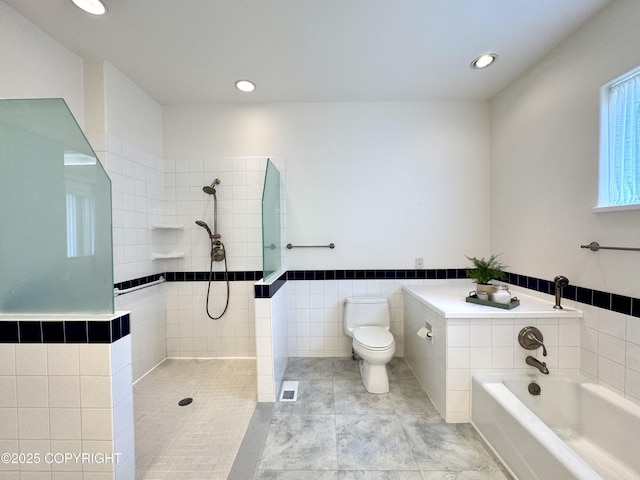 1103 Inlet Woods Dr, Kenai, AK 99611 - bathroom with tile walls, a garden tub, a tile shower, recessed lighting, and wainscoting