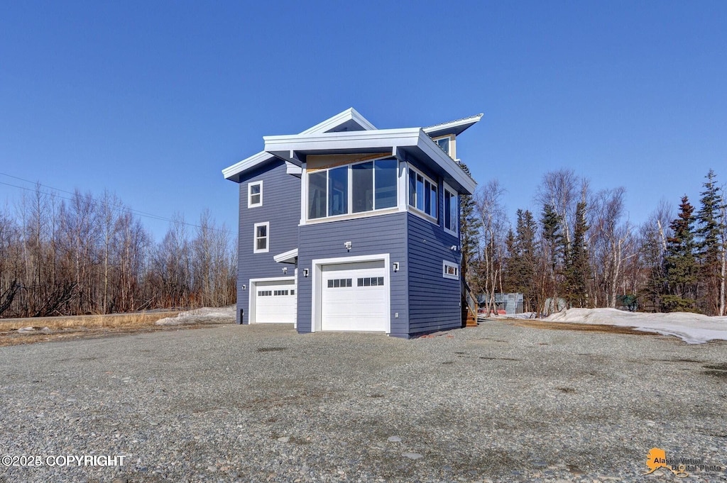 445 Westcove Dr, Wasilla, AK 99654 - view of property exterior featuring gravel driveway and a garage