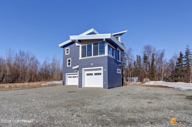 445 Westcove Dr, Wasilla, AK 99654 - view of property exterior featuring gravel driveway and a garage