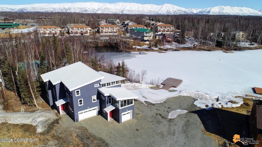 445 Westcove Dr, Wasilla, AK 99654 - snowy aerial view with a mountain view and a wooded view