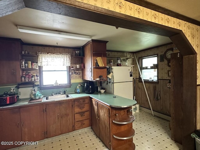 339 Cassiar St, Wrangell, AK 99929 - kitchen with open shelves, wallpapered walls, light flooring, freestanding refrigerator, and a baseboard heating unit