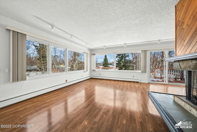 1521 Cache Dr, Anchorage, AK 99507 - unfurnished sunroom featuring track lighting and a baseboard radiator