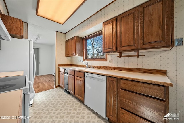 1521 Cache Dr, Anchorage, AK 99507 - kitchen with white appliances, light floors, wallpapered walls, light countertops, and ventilation hood