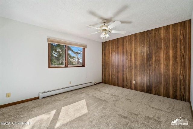 1521 Cache Dr, Anchorage, AK 99507 - unfurnished room with a baseboard radiator, wood walls, ceiling fan, and carpet flooring