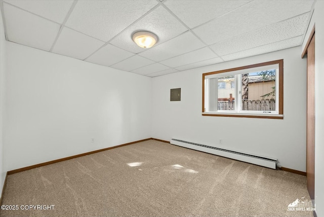 1521 Cache Dr, Anchorage, AK 99507 - empty room featuring baseboard heating, a drop ceiling, and carpet floors
