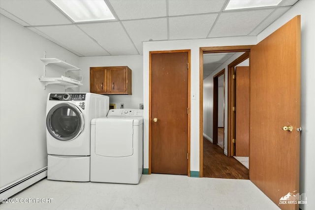 1521 Cache Dr, Anchorage, AK 99507 - laundry area featuring a baseboard heating unit, cabinet space, washing machine and dryer, and light flooring