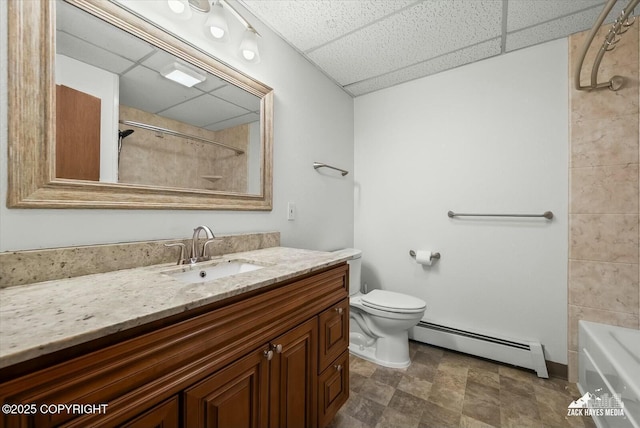 1521 Cache Dr, Anchorage, AK 99507 - bathroom featuring baseboard heating, a drop ceiling, vanity, stone finish flooring, and tub / shower combination