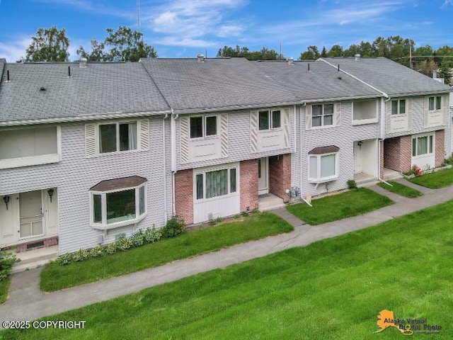 3265 Montclair Ct # 17E, Anchorage, AK 99503 - view of property with a front yard and brick siding