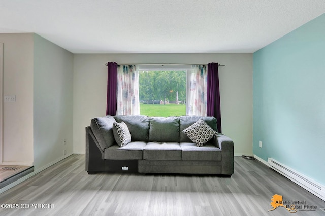 3265 Montclair Ct # 17E, Anchorage, AK 99503 - living room with baseboard heating and wood finished floors