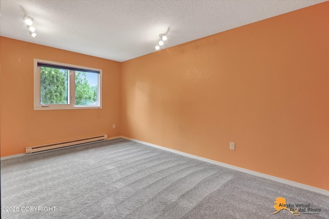3265 Montclair Ct # 17E, Anchorage, AK 99503 - carpeted spare room featuring baseboard heating, rail lighting, and a textured ceiling