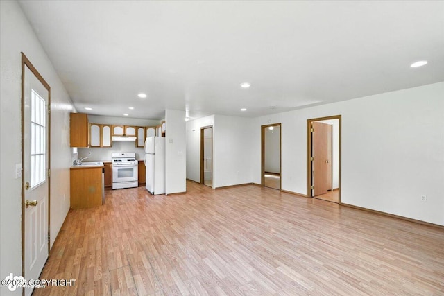 6710 W Joes Dr, Wasilla, AK 99623 - unfurnished living room with light wood-style flooring and recessed lighting