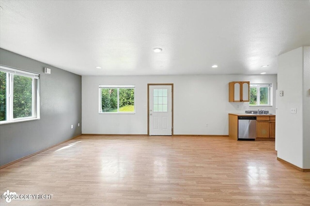 6710 W Joes Dr, Wasilla, AK 99623 - unfurnished living room with healthy amount of natural light, light wood-style floors, and recessed lighting