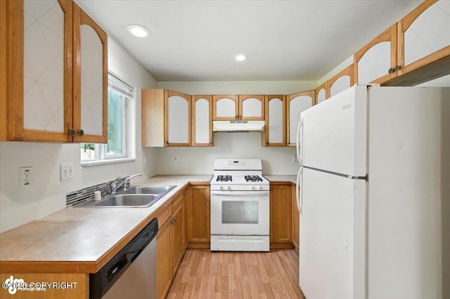 6710 W Joes Dr, Wasilla, AK 99623 - kitchen with white appliances, under cabinet range hood, light wood-style flooring, light countertops, and glass insert cabinets