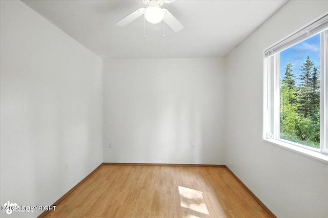 6710 W Joes Dr, Wasilla, AK 99623 - empty room featuring healthy amount of natural light, light wood finished floors, and a ceiling fan