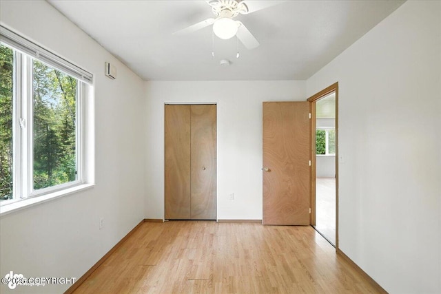 6710 W Joes Dr, Wasilla, AK 99623 - unfurnished bedroom with light wood-style floors, ceiling fan, and a closet