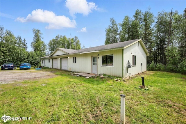 6710 W Joes Dr, Wasilla, AK 99623 - ranch-style house with an attached garage, a front lawn, and driveway