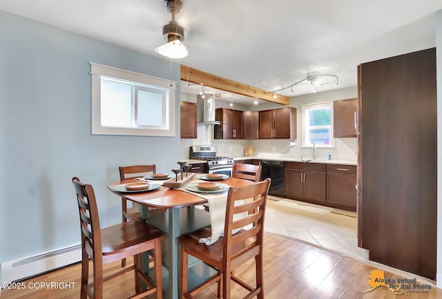 3306 E 19th Ct, Anchorage, AK 99508 - dining room featuring a baseboard heating unit and light wood finished floors