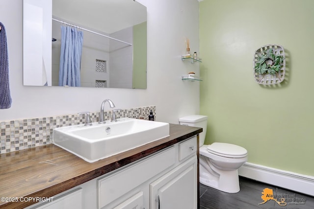 3306 E 19th Ct, Anchorage, AK 99508 - full bath with a baseboard radiator, tasteful backsplash, vanity, and curtained shower