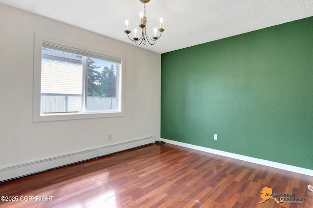 3306 E 19th Ct, Anchorage, AK 99508 - empty room with a baseboard radiator, a chandelier, and wood finished floors